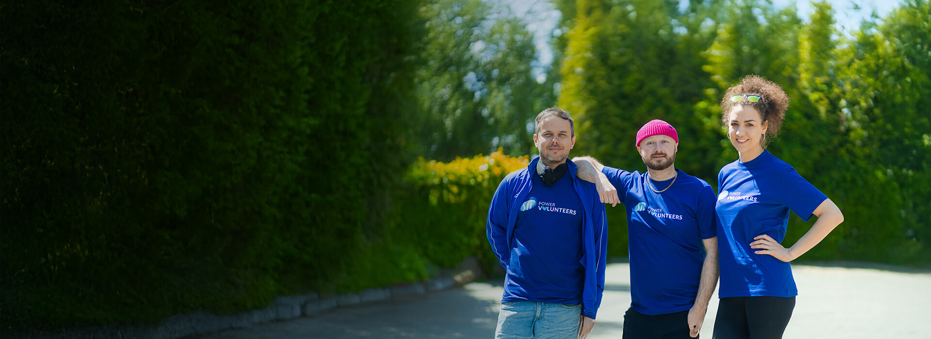 Three people in Sii Power Volunteers t-shirts